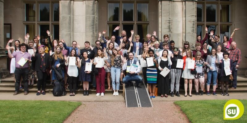 Group of Keele Volunteers smiling and holding certificates 